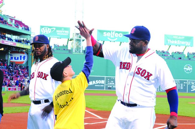 ➥➥ Yhan Cruz Maldonado student of the Browne School in Chelsea high fives David “Big Papi” Ortiz during the first Latino Youth Recognition Day at Fenway Park.