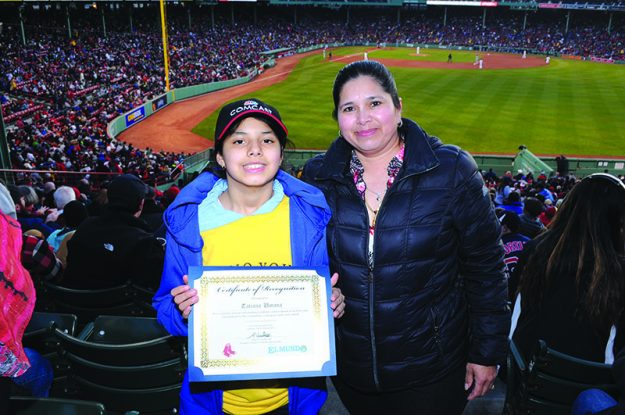 ➥➥ Academic star Tatiana Umana from the eight grade at Clark Middle School in Chelsea shows the recognition next to her mother after being recognized at Fenway Park.