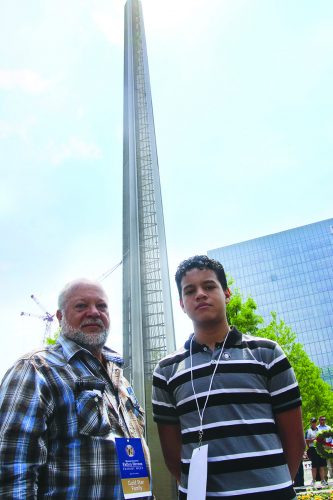➥➥ Andy Jiménez y su hijo Alexander Jiménez posan delante del monumento dedicado a los soldados procedentes de Massachusetts que fallecieron en Iraq y Afganistán.