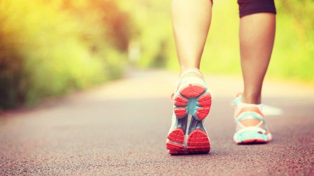 young fitness woman hiker legs at forest trail