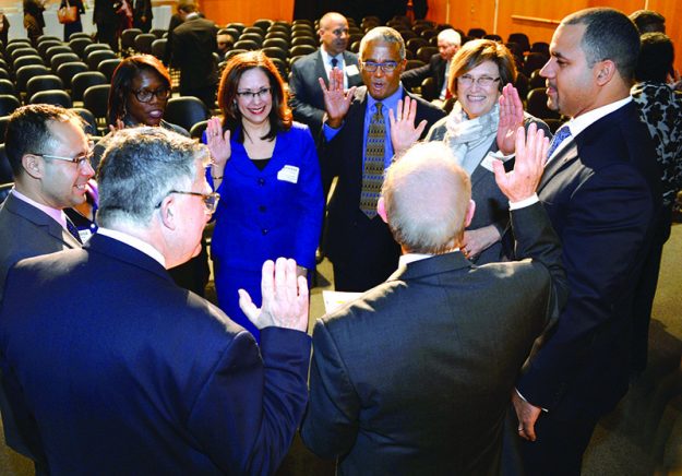 ➥➥Quincy Miller taking an oath during the Eastern Bank annual meeting March 2016.