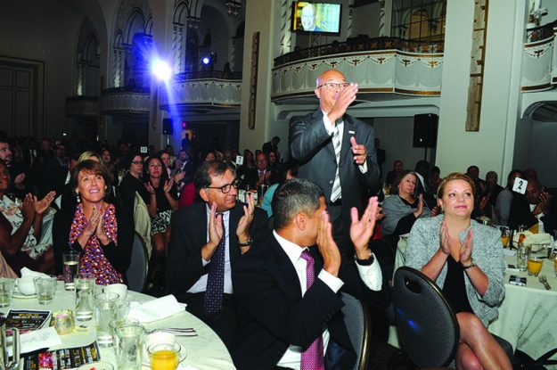Gerald C. Francis, President of Keolis Commuter Services, salutes the head table during the El Mundo Hispanic Heritage Breakfast.