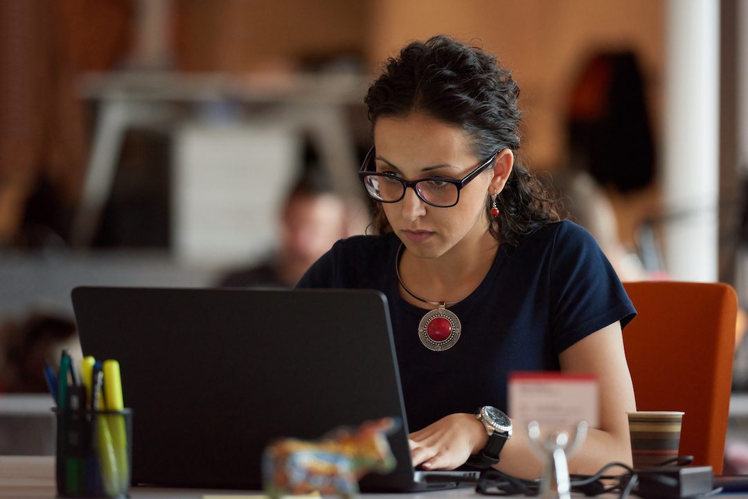 Startup business, woman working on laptop computer at modern office