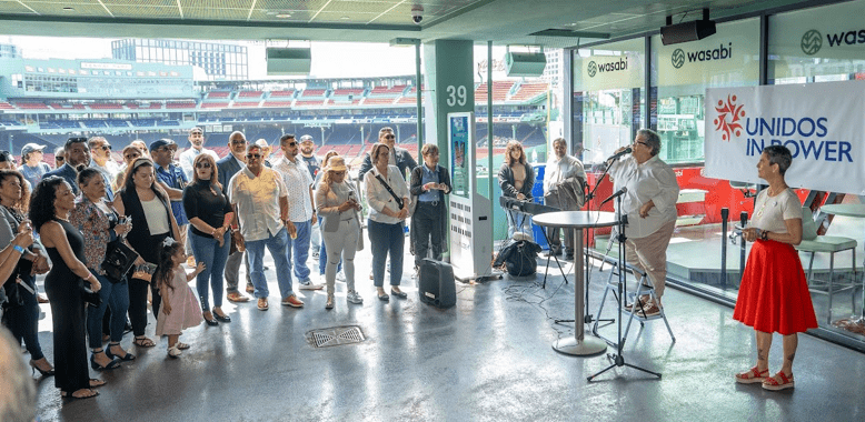 Grace Moreno of the executive committee of Unidos in Power at Fenway Park last Sunday. Zamawa Arenas, another founding member, looks on.